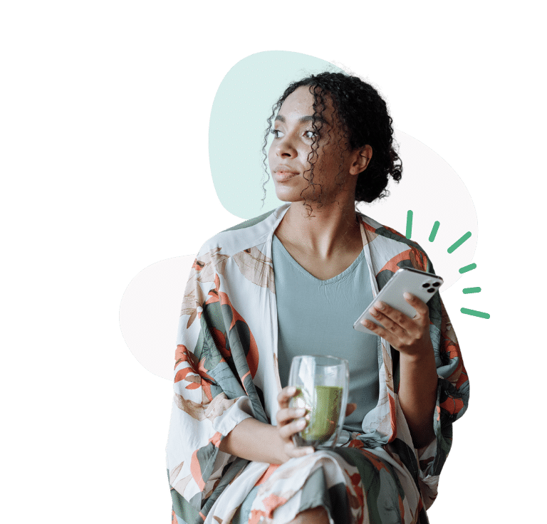 Woman holding glass and phone making an appointment for a pregnancy consultation.